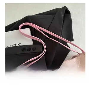 Pink silk tote bag featuring butterfly embroidery and white bead charms on black fabric