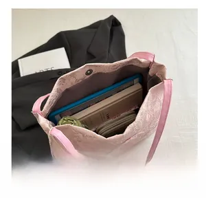 Spacious pink lace tote bag showing large storage capacity for tablet and daily items