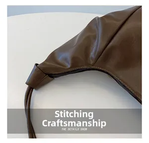 Detail shot of a dark brown patchwork bag showing smooth zipper and fine stitching craft