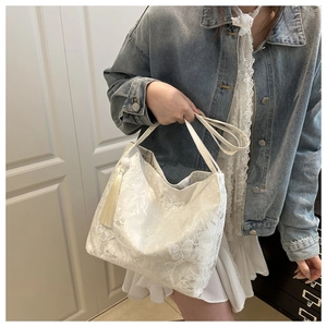 White lace hobo shoulder bag with butterfly embroidery and stylish tassel detail