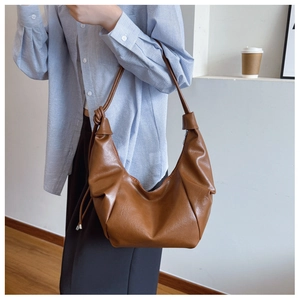 Brown PU leather hobo bag featuring vintage pleats and a decorative knot on the shoulder strap
