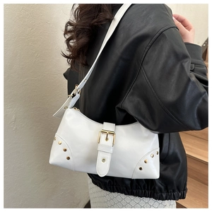 White rivet shoulder bag worn with a black leather jacket for a stylish streetwear look