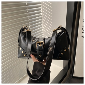 Glossy black underarm bag with vintage gold hardware buckles and rivet details