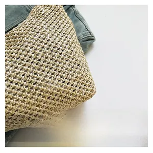 Close-up of hand-woven natural straw tote bag texture with detailed plant fiber patterns