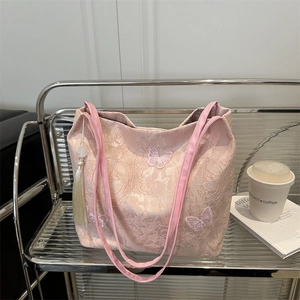 Chic pink lace tote bag featuring 3D butterfly embroidery and a delicate beaded tassel
