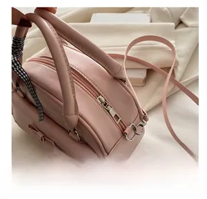 Nahaufnahme der rosa Schleifenhandtasche mit glattem Reißverschluss und Spitzenbesatz