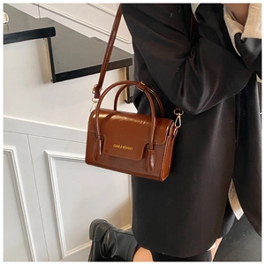 Caramel brown handbag with 'FASHION & BAGS' logo shown on a fashion model's side
