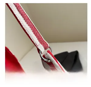 Close-up of silver ring connector on a red and white striped canvas tote bag detail