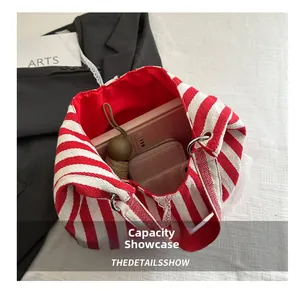 Interior view of striped tote bag showing large capacity for umbrella, wallet and books