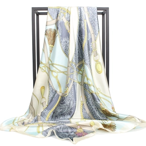 Elegant 90cm square silk scarf with baroque chain print displayed on a black metal rack