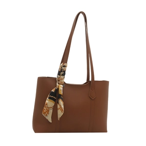 Classic brown faux leather tote bag with vintage printed silk scarf on the handle