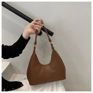 Close-up of brown woven leather texture on hobo bag with precision craftsmanship