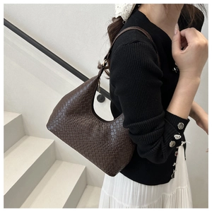 Detail of dark brown woven PU leather hobo bag with intricate cross-stitch texture