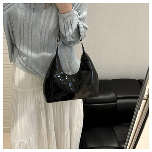 Chique zwarte lakkleren hobo-tas gestyled met een outfit voor een modieuze look
