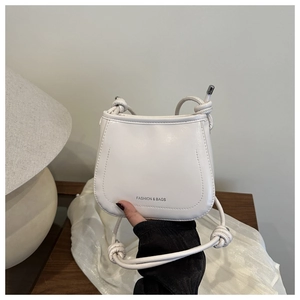 Close-up of a white vintage small square bag with knot shoulder strap and printed logo