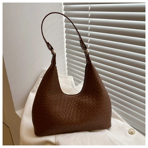 Close-up of dark brown woven faux leather texture on a hobo shoulder bag with zipper