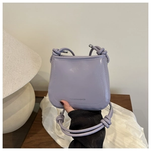 Detail of lavender purple glossy leather shoulder bag with FASHION & BAGS silver lettering