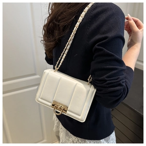 Detailed side view of white quilted chain bag featuring elegant vertical stitching