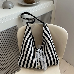 Striped canvas tote bag with white lace bow and handmade tag for daily use