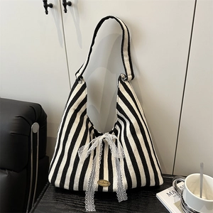 Minimalist black and white striped canvas tote bag with lace bow and handmade metal tag