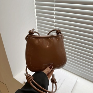Chic brown saddle bag with knotted shoulder strap and vintage minimalist design