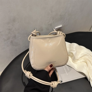 Retro beige glossy crossbody bag with knot shoulder strap and fashion text detail