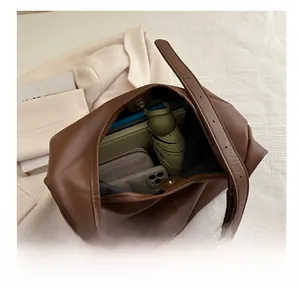 Detail view of the spacious interior of a brown leather tote bag with magnetic closure