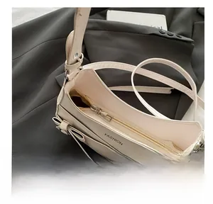 Detail view of the smooth metal zipper and internal structure of the beige tote bag