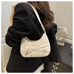 Close-up of white PU leather crescent bag featuring crisscross straps and silver buckles