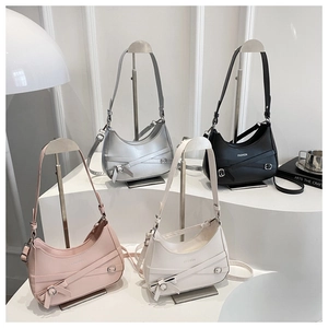 Detailed display of four colorful crescent hobo bags on minimalist studio pedestals
