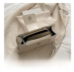 Detailed interior view showing large capacity of the beige leather chain bag