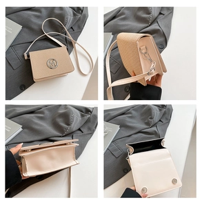 Detail shots of beige woven crossbody bag with round M logo and magnetic closure