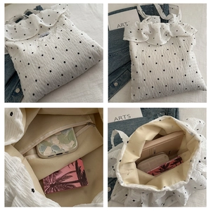 Detail view of floral mesh tote bag showing spacious interior with zipper pocket and ruffles