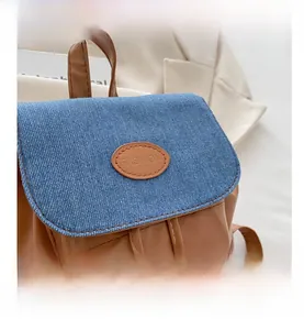 Detail of brown PU leather and blue denim stitching with white double stitching finish