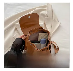 Interior view of brown PU leather backpack showing spacious capacity for essentials