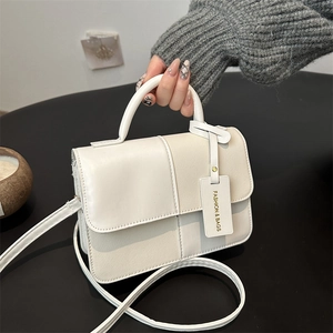 Minimalist square tote bag in white and beige faux leather with geometric stitching