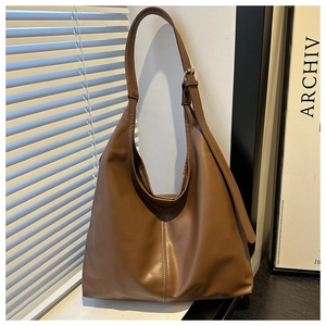 Detailed close-up of brown large-capacity Hobo bag with adjustable strap and contrast stitching