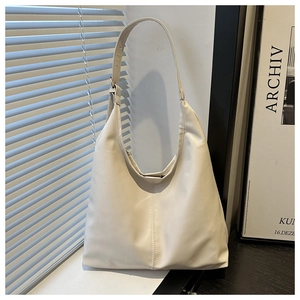 Detail of cream PU leather shoulder bag with vertical stitching and adjustable buckle strap