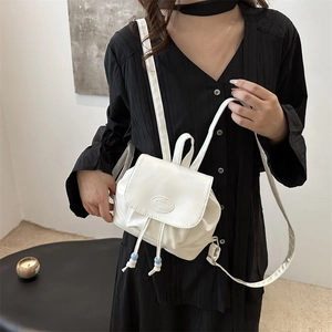 Minimalist white PU leather mini backpack for women featuring a stylish drawstring design