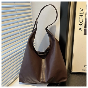 Detailed view of deep brown matte PU leather Hobo bag with adjustable silver buckle strap