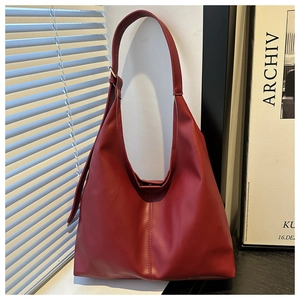 Detailed texture of dark red PU leather tote bag with vintage matte finish and stitching