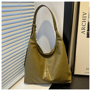 Detail view of large olive green PU leather tote bag with vertical stitching
