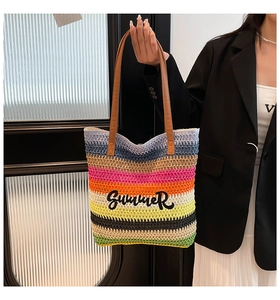 Close-up of vibrant rainbow woven tote bag featuring Summer embroidery and leather handles