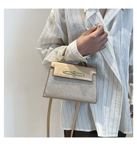 Detail of champagne gold flap and silver glitter texture on a luxury crossbody bag