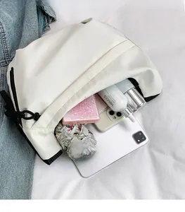 Interior view of off-white tote bag showcasing large capacity with iPad and daily items