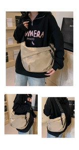 Three-way view of beige nylon crescent tote bag with wide black adjustable shoulder strap