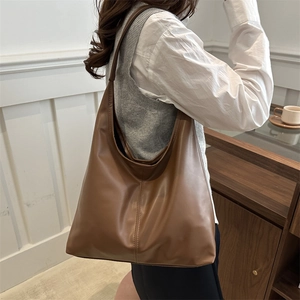 Brown vintage PU leather large hobo shoulder bag shown from a side view on model