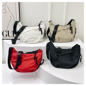 Detail of four colorful nylon crescent bags showing adjustable straps and front zip pockets