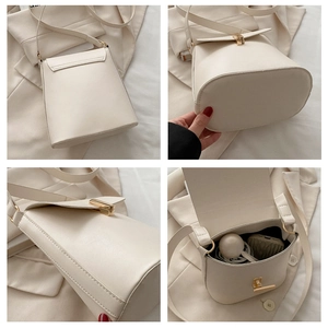 Détails de l'intérieur et de la base d'un sac seau crème avec boucle en métal doré