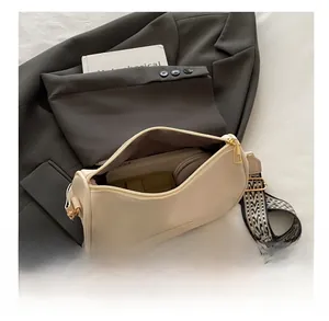 Interior view showing the capacity of a beige vintage bag with wide jacquard strap